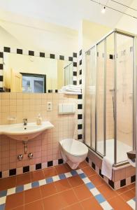 a bathroom with a sink and a toilet and a shower at Landhotel Kistlerwirt in Bad Feilnbach