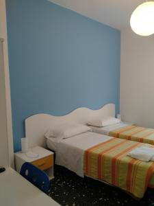 A bed or beds in a room at Albergo Belvedere