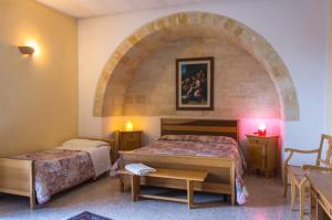 A bed or beds in a room at Casale Sombrino