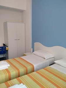 A bed or beds in a room at Albergo Belvedere