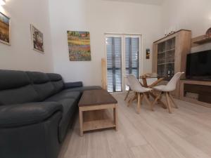 a living room with a couch and a table and chairs at To Be (2B) in Malaga in Málaga