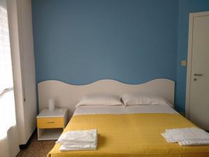 A bed or beds in a room at Albergo Belvedere