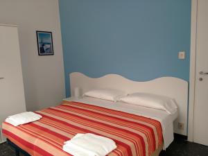 A bed or beds in a room at Albergo Belvedere