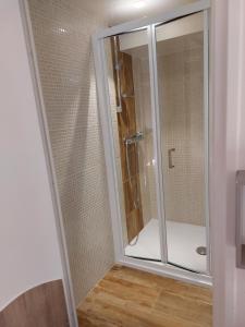 a shower with a glass door in a bathroom at Logis hôtel restaurant le relais de l'abbaye in Saint-Évroult-Notre-Dame-du-Bois