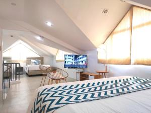 a bedroom with a bed and a living room at Grand Blue Beach Hotel in Boracay