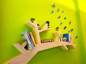 a book shelf with books and people sitting on it at CHI-YU B&B in Chaozhou