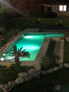 a swimming pool in a yard at night at B&Bio Garda Ulivi in Nago-Torbole