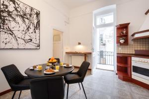 a kitchen and dining room with a table and chairs at BpR Swan apartment near the Buda Castle in Budapest