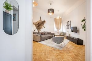 a living room with a couch and a television at BpR Swan apartment near the Buda Castle in Budapest
