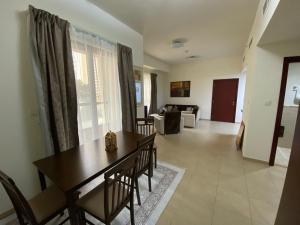a dining room and living room with a table and chairs at 1 Bedroom in Jumeirah Beach Residence Dubai in Dubai