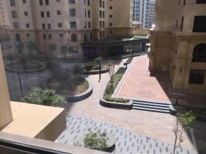 a view of a courtyard in a city with a fountain at 1 Bedroom in Jumeirah Beach Residence Dubai in Dubai