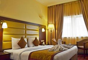 Кровать или кровати в номере Orchid Hotel