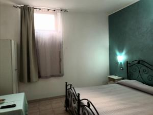 Postel nebo postele na pokoji v ubytování Il Rifugio dell'Ape Agriturismo