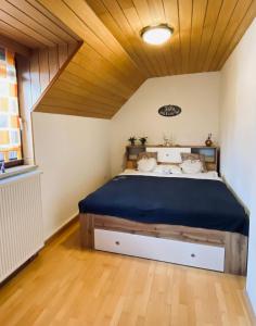 a bedroom with a large bed with a wooden ceiling at Ferienhaus Silke in Knittelfeld