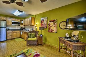 a kitchen with green walls and a table with a desk at GARDEN VIEW STUDIO - KONA ISLANDER INN CONDOS condo in Kailua-Kona