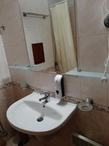 a bathroom with a white sink and a mirror at Сладко студио в Пирин с голф и СПА комплекс in Razlog