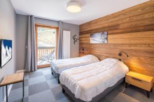 Postel nebo postele na pokoji v ubytování Vacancéole - Les Ecrins d'Auris