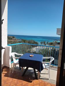 a table and two chairs on a balcony with the ocean at Le Dune camere in Otranto
