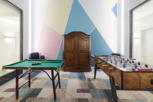 a room with a pool table and a foos ball at Kreuz Bern Modern City Hotel in Bern