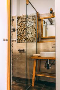 a bathroom with a glass shower and a sink at Villa Šumik- Peaceful Hideaway in Ruše