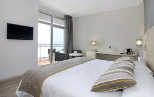 a hotel room with a bed and a television at Medplaya Hotel Riviera - Adults Only in Benalmádena