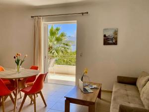 a living room with a couch and a table at Manolis Apartments plakias in Plakias
