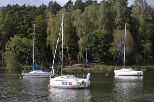 three boats sitting in a body of water at Apartament Leśny No 64 nad Zalewem JACUZZI, KOMINEK z Garażem w cenie in Kielce