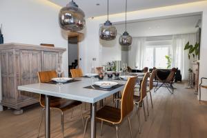 a dining room with a white table and chairs at #MacLeod2 in Ostend