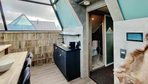 a bathroom with a sink and a bathroom with a window at Aurora Pyramid Glass Igloos in Köngäs