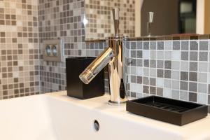 a sink with a faucet on top of a bathroom at #MacLeod2 in Ostend