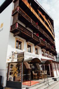 a hotel colombian center with a sign in front of it at Hotel Goldener Greif in Kitzbühel