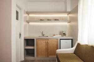 a small kitchen with a sink and a counter at Kanala Studios in Kithnos