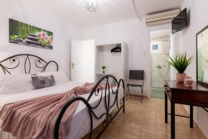 a bedroom with a large bed and a desk and a desk at Zante Riva Studios in Lithakia