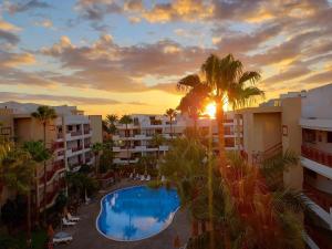 a view of a resort with a pool and palm trees at Andromeda in Palm-Mar