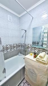 塔拉茲的住宿－Абсолютно новая квартира класса ЛЮКС，带浴缸和盥洗盆的浴室