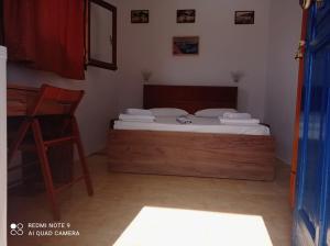 a bedroom with a bed and a desk at Faragi in Agia Roumeli