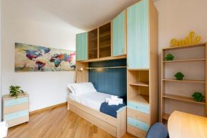 a small bedroom with a bed and shelves at Piazza delle Vettovaglie Historic Center Eco Flat in Pisa
