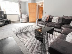 a living room with a couch and a table at Nant House in Wrexham