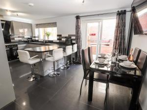 a kitchen with a dining room table and chairs at Nant House in Wrexham