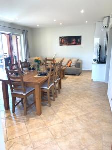 a living room with a wooden table and chairs at Apartments Plazs 41 in Sukošan