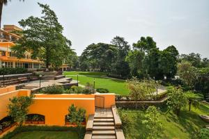 a large green building with trees and grass at Fariyas Resort Lonavala in Lonavala