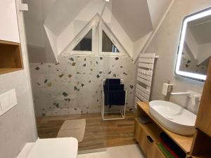 a bathroom with a sink and a toilet and a window at DOM NA KASZUBACH, SAUNA i BALIA in Nowe Czaple