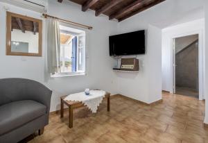a living room with a couch and a table at Sofaki Milos in Tripiti