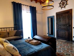 a living room with a bed and a couch at Appartamento Porto Marina S G 2 in Licata