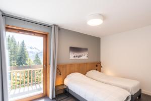 Postel nebo postele na pokoji v ubytování Vacancéole - Les Ecrins d'Auris