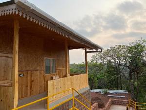 a house under construction with a porch at santanas wooden cottages in Bogmolo