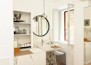 a bathroom with a sink and a mirror at Wilena Apartments in Piran