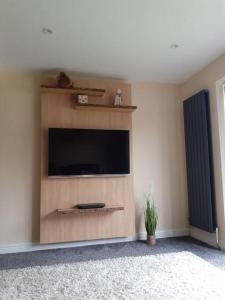 a living room with a flat screen tv on a wall at Alexandra place Skipton child and dog friendly in Skipton