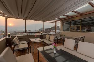 a restaurant with tables and chairs and a view of the city at Himalayan Ghar in Kathmandu