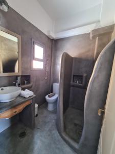 a bathroom with a sink and a toilet in it at Amfitriti in Livadion